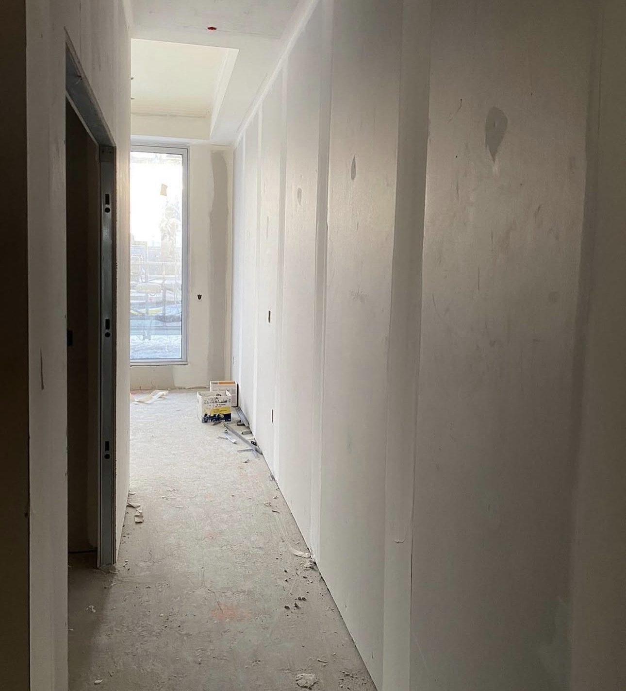 Taped and sanded drywall hallway ready for paint